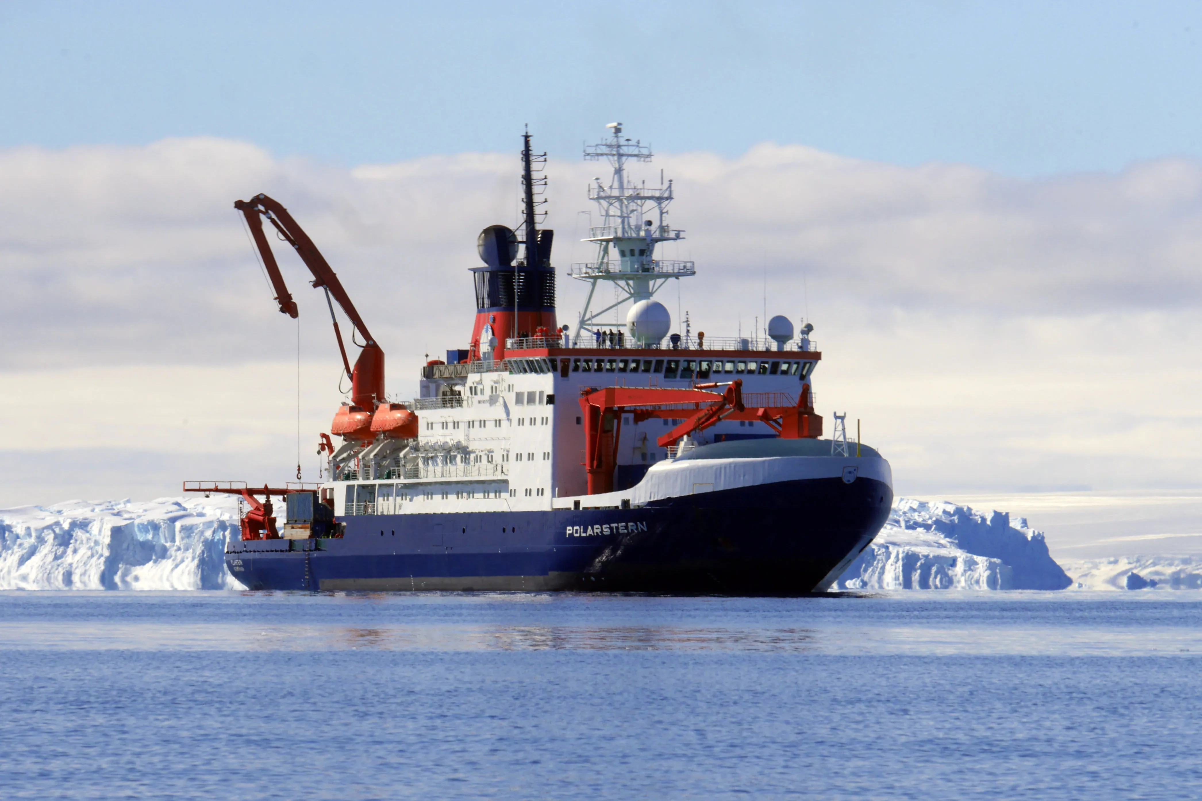 Polarstern, a blue and white icebreaker, at rest against a background of ice.